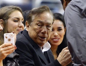 L. A. Clippers owner has long history of discrimination is seen with his black and Mexican American girlfriend. Photo Credit: The Associated Press, Mark J. Terrill.